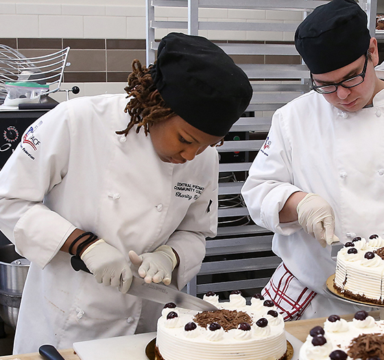 Baking and Pastry Arts program students cutting cakes