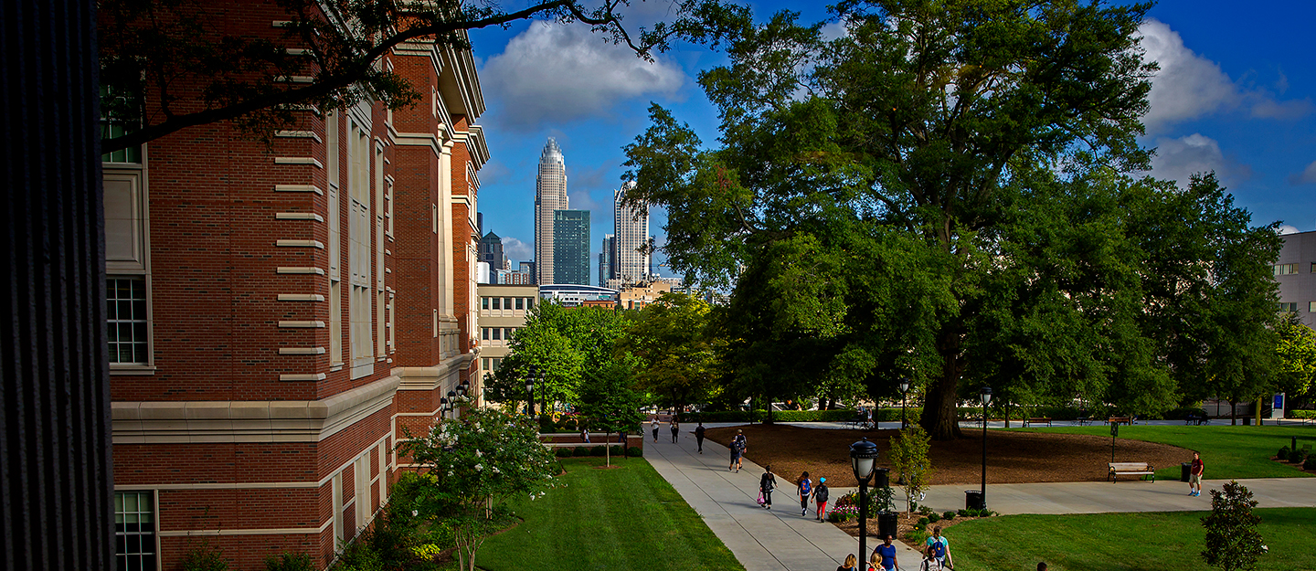 view of downtown Charlotte from Central Campus with students walking around