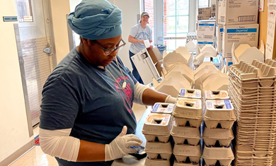 female volunteer packaging eggs