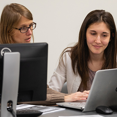 Career Services advisor helping student in lab