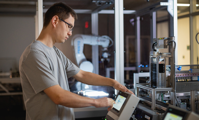 Male student working on robotics machine