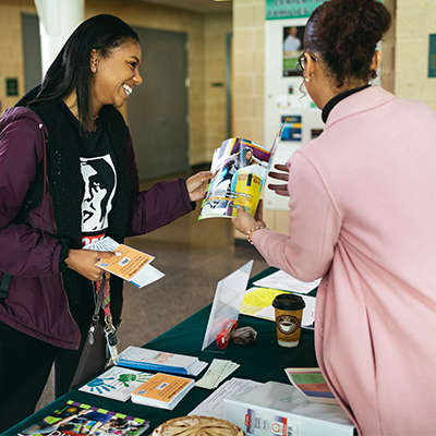 staff member showing a student information 