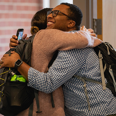 students hugging on first day at Levine Campus