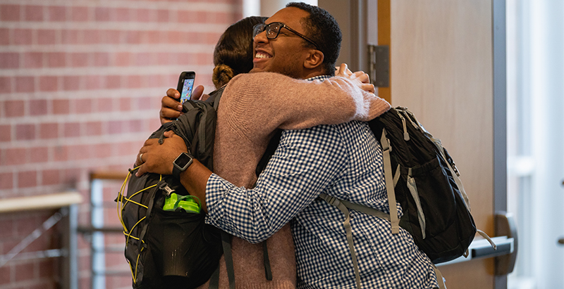 students hugging on first day of class at Levine Campus