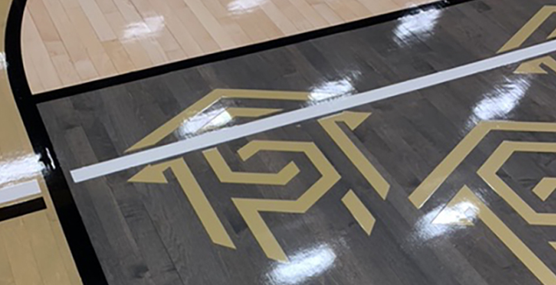 Central Piedmont logo on the free-throw lane of Worrell Gym