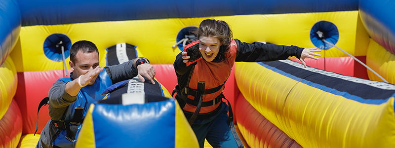 2 students racing on an inflatable track