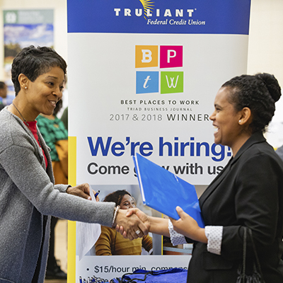 student shaking hand with potential employer at Central Piedmont Career Fair