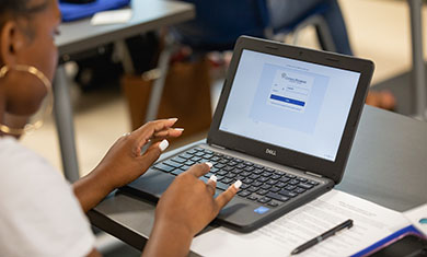 Student sitting in front of Chromebook