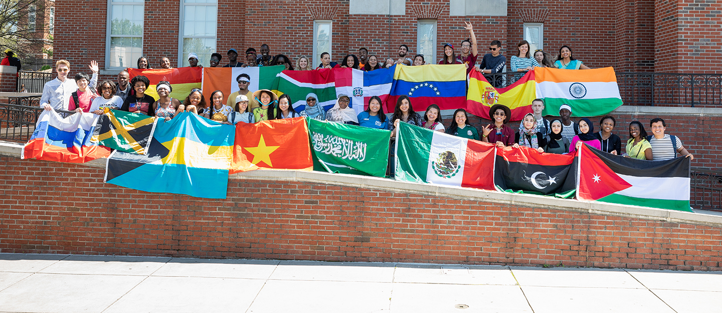 group of students with flags from around the world