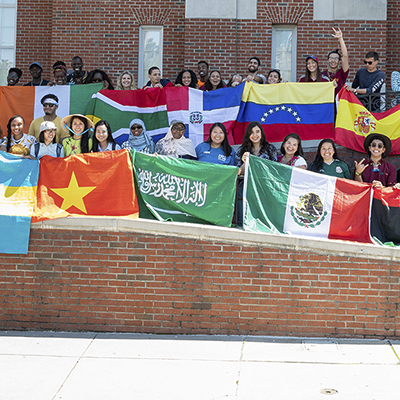 international students with their countries' flags