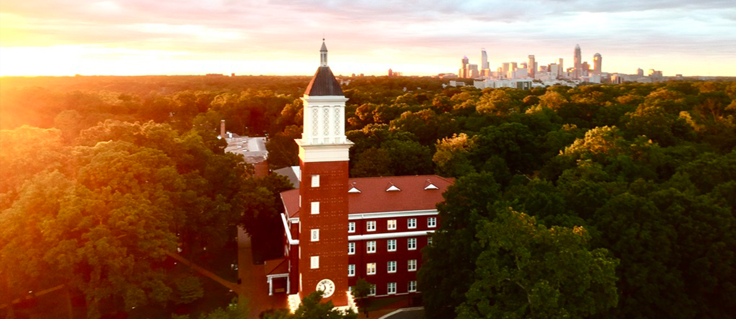 Queens University of Charlotte campus with trees and Charlotte skyline