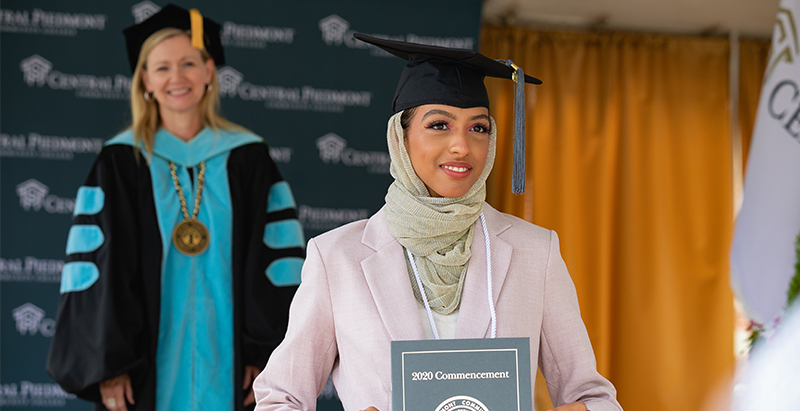 student standing with Dr. Deitemeyer at graduation