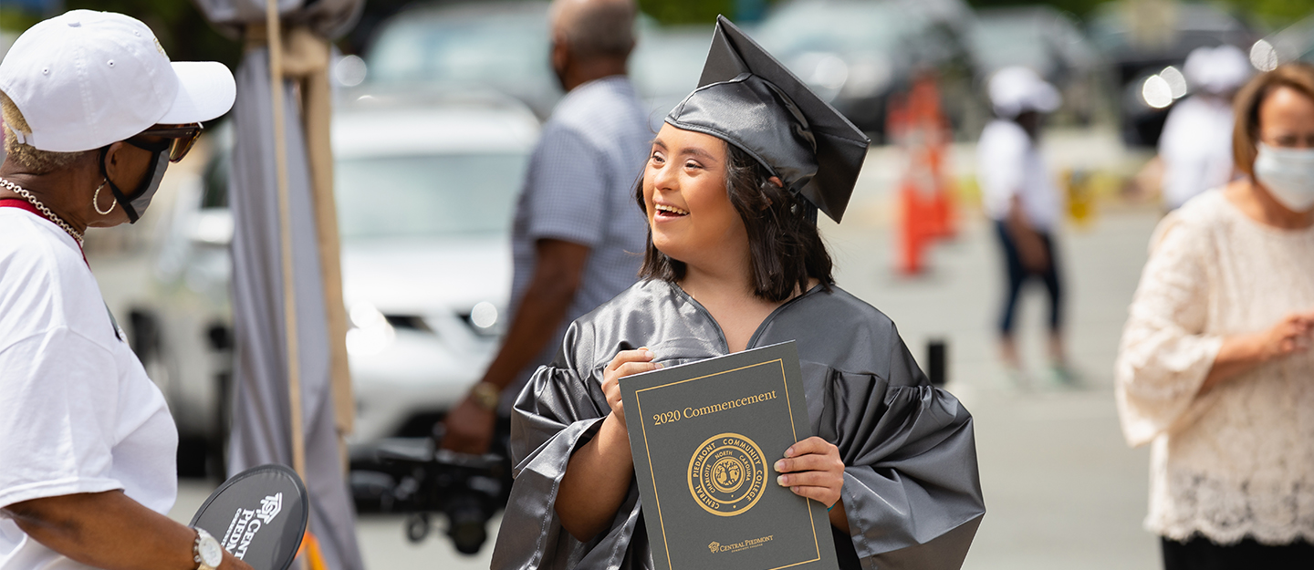 student in cap and gown at graduation