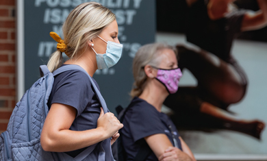 Health Careers students walking on campus wearing masks