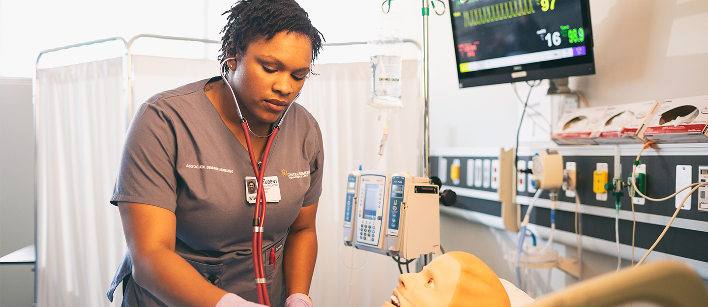 nursing student taking patient's vitals