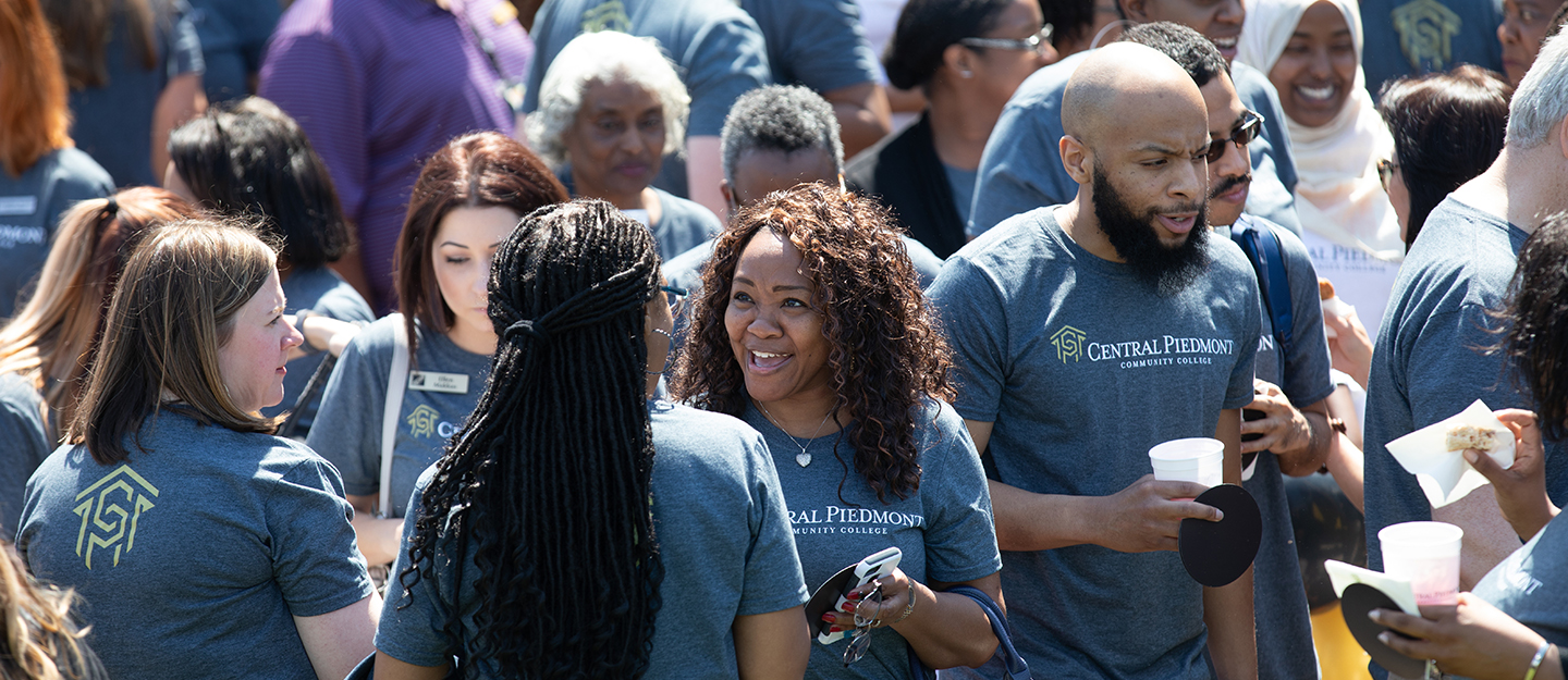 group of diverse employees in a crowd on campus