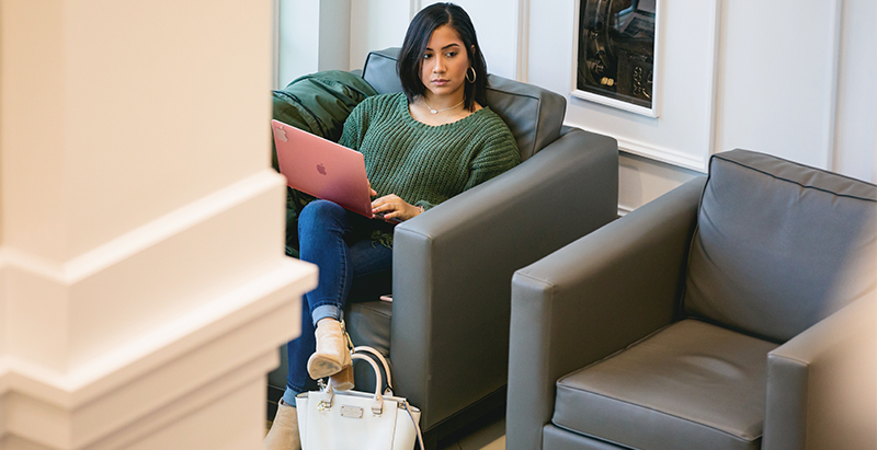 student on laptop in sitting area