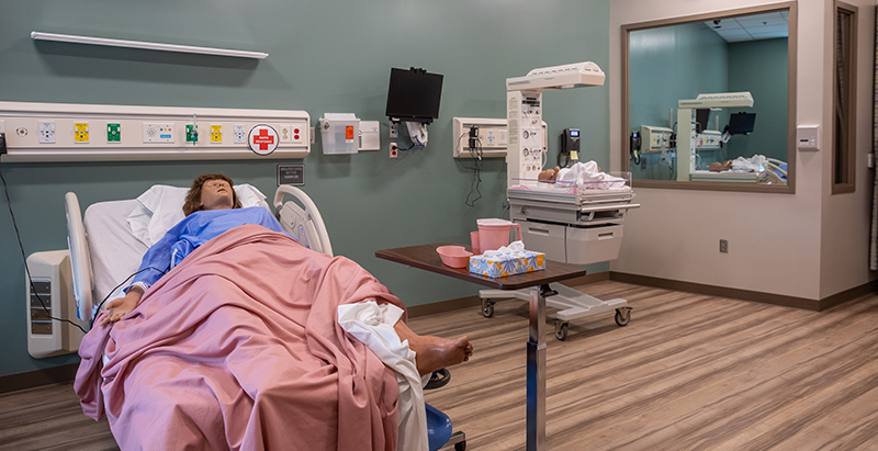 Central Piedmont simulation maternity room with dummy patient and baby