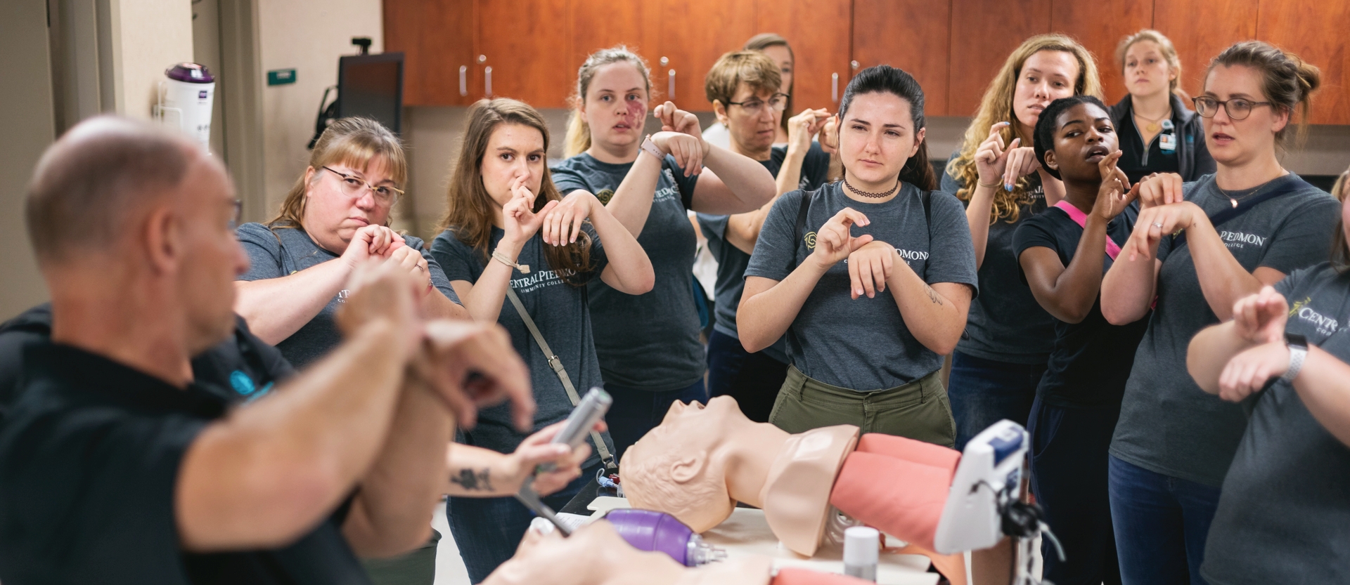 diverse group of Central Piedmont interpreter education students learning ASL signs