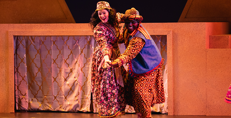 two actors from joseph and the amazing technicolor dreamcoat dancing together on stage