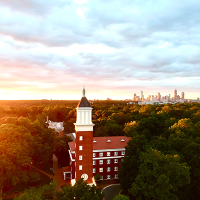 Queens University of Charlotte campus with trees and Charlotte skyline