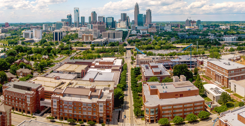 aerial view of Central Campus with Charlotte skyline behind