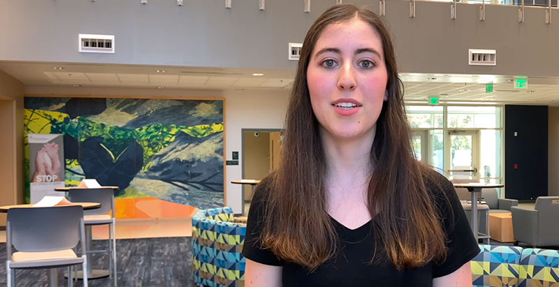 student Lydia Connelly smiling in a Levine Campus lobby