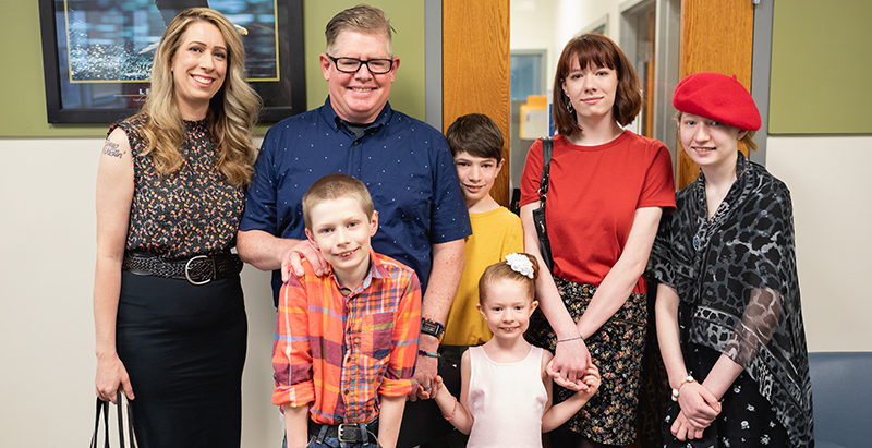 military veteran and family standing facing the camera during a recognition event