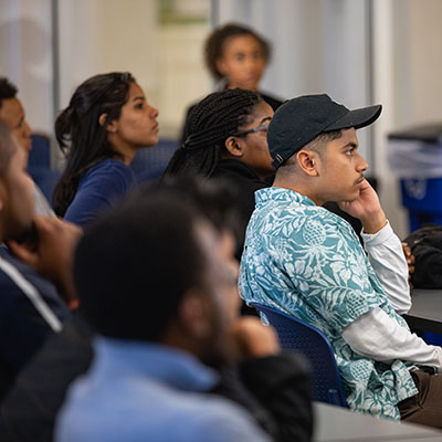 group of diverse students listening in a classroom