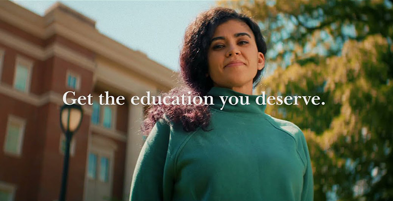 Central Piedmont scholarship recipient Natasha smiling confidently on Central Campus with the words "Get the education you deserve."