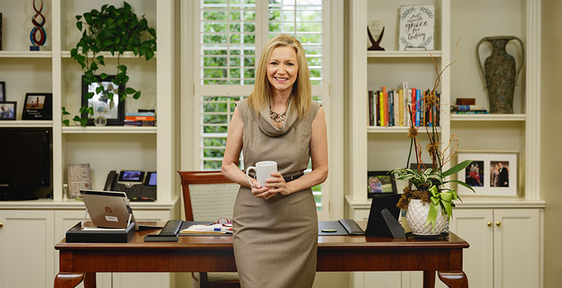 CPCC president Dr. Kandi Deitemeyer standing in her office at Central Piedmont