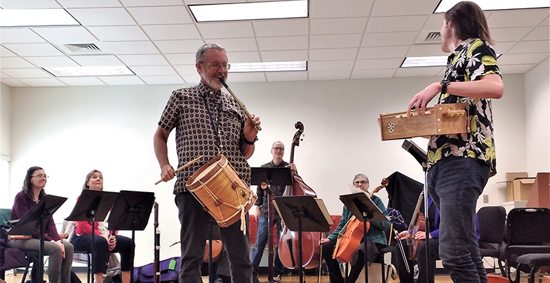 Central Piedmont early music consort students smiling and practicing in a classroom