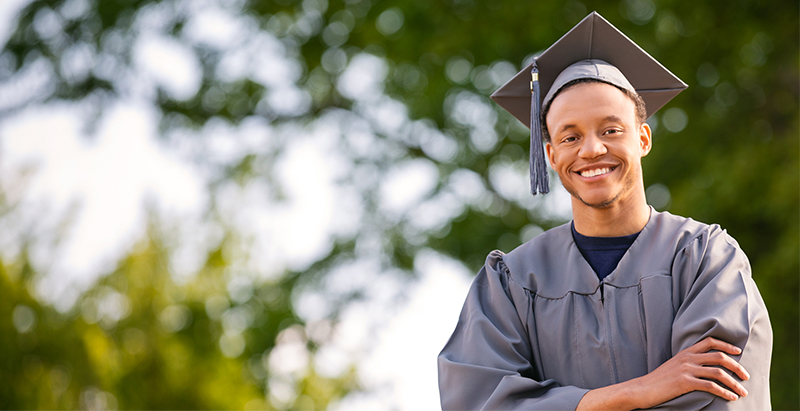 diverse student outside in graduation cap and gown