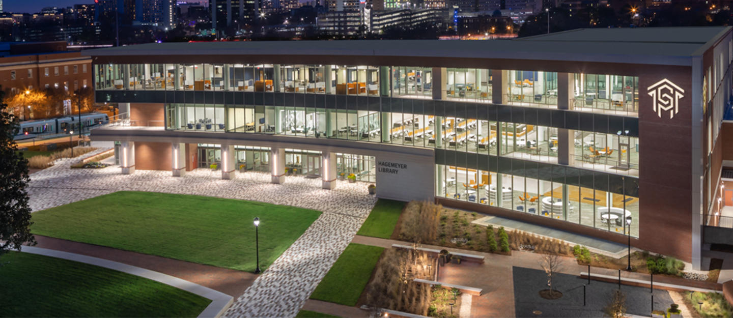 Student Success Center exterior at night with lights on in the building