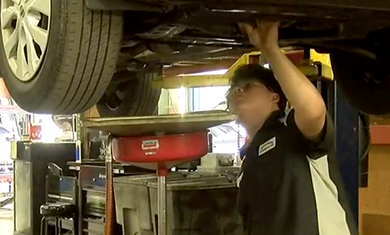 Student Working Under Car