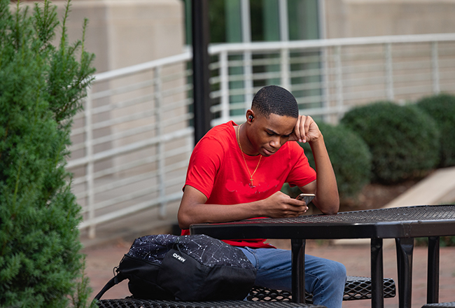 African American male studying outside