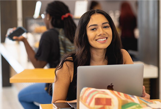 Young female student with her laptop in the Parr Center