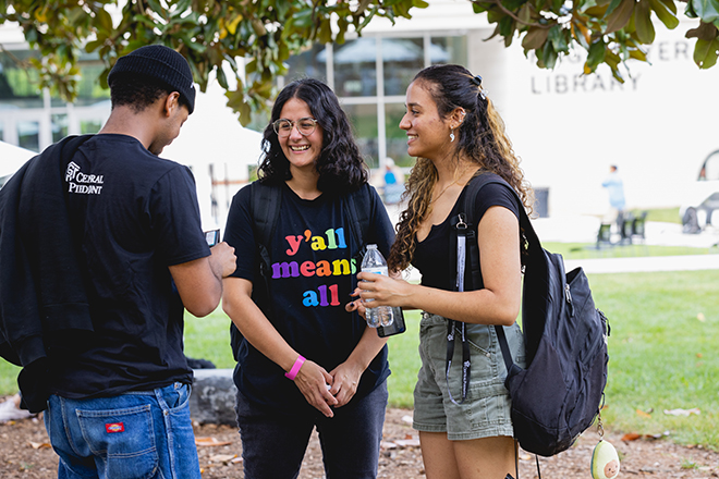 Three students outside of the Hagemeyer Library