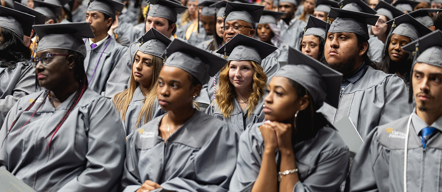 diverse group of students in cap and gown at graduation