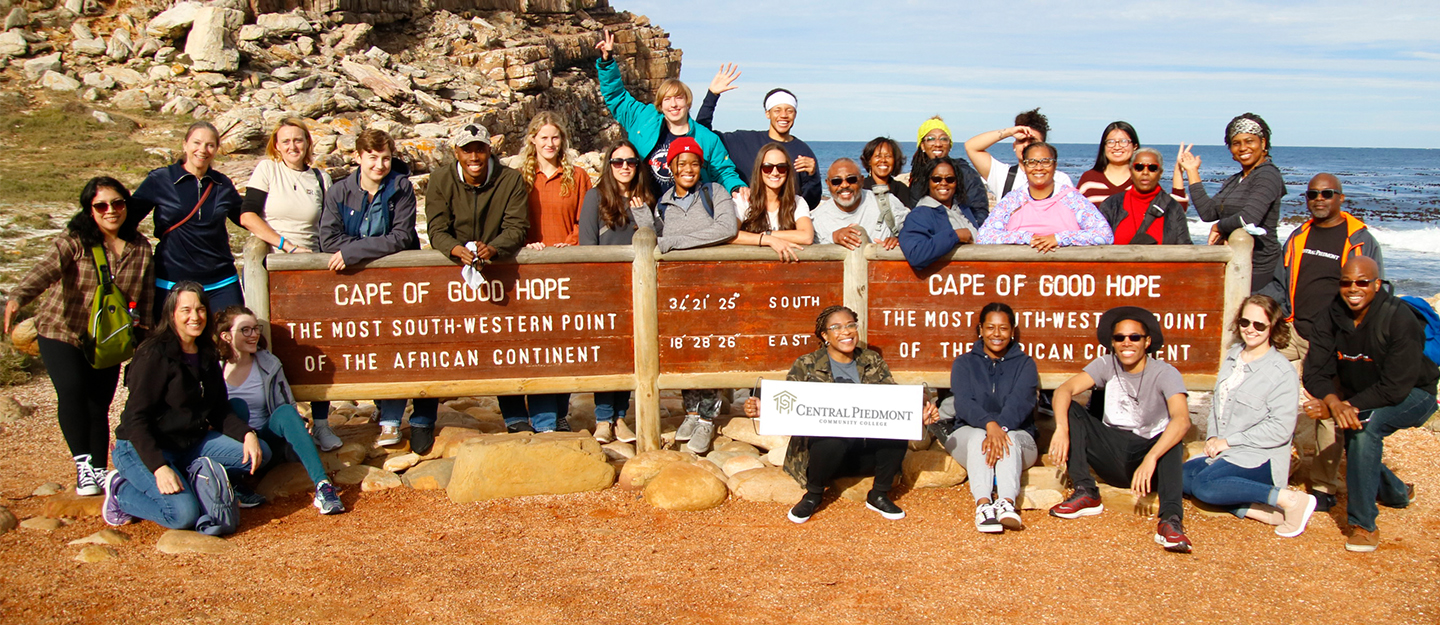 group of diverse Central Piedmont Students in front of beach in Cape of Good Hope, South Africa