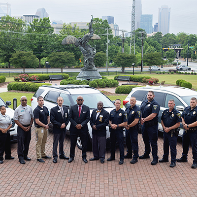 college security officers standing outside in front of vehicles