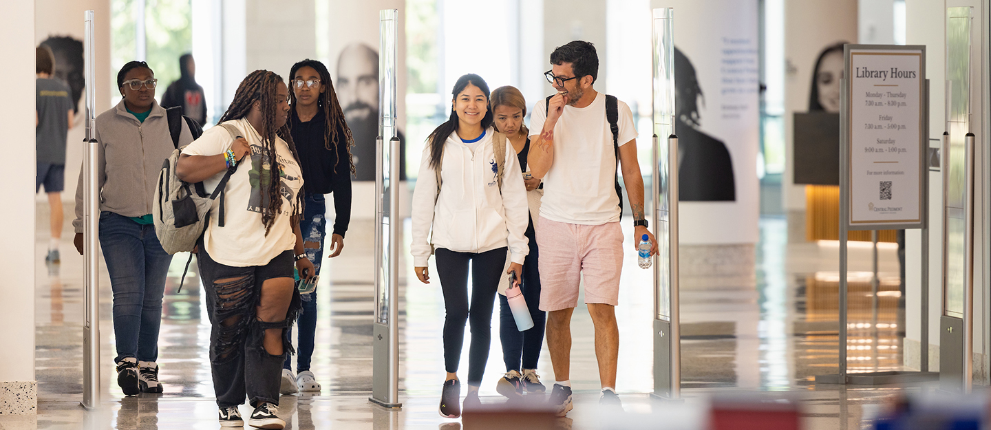 diverse Central Piedmont students walking through the Library