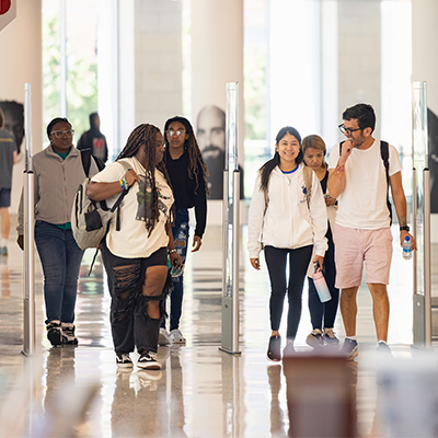 diverse Central Piedmont students walking inside library on Central Campus