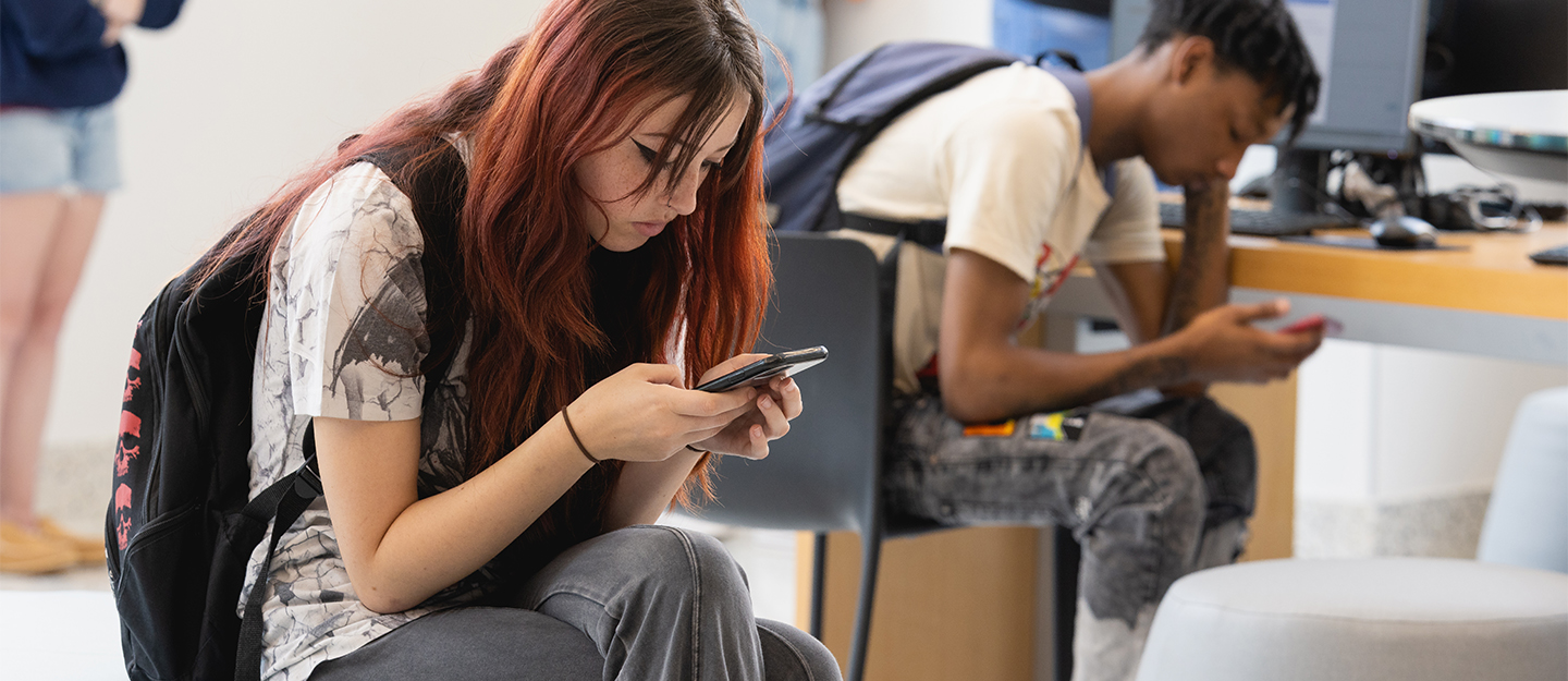 Two students looking at their smartphones