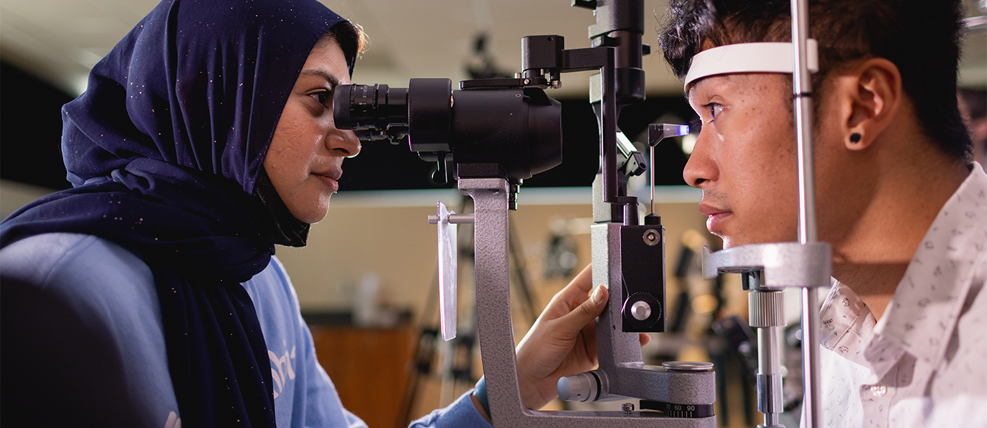 A student conducting an eye exam at Central Piedmont