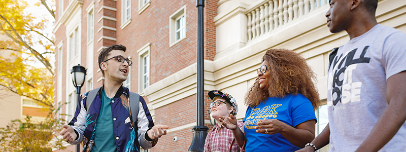 group of student walking and talking on campus