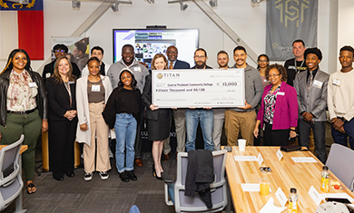 Central Piedmont leadership with students and Titan Solar Power donors holding grant check 