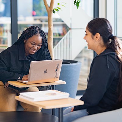 Two students working in the library on the Central Campus