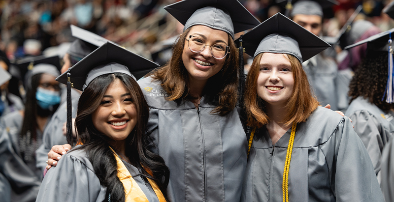 Three graduates at 2022 commencement