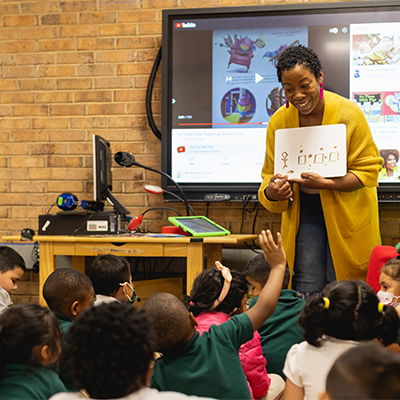 A teacher helping young students learn to code at WTVI